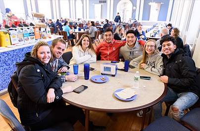 students sitting at a table in the cafeteria
